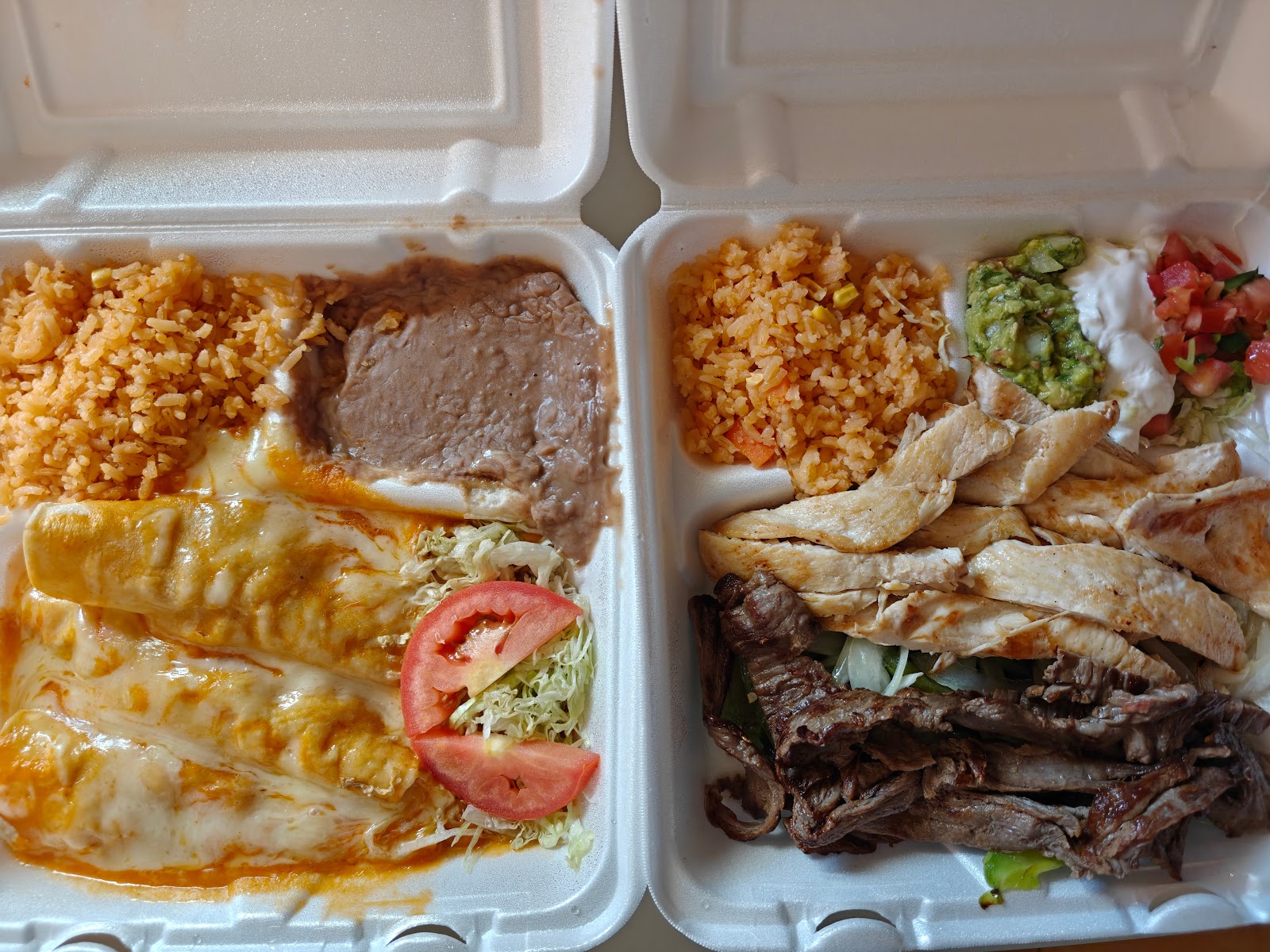 Combo plate with enchiladas, rice, beans, and mixed fajitas
